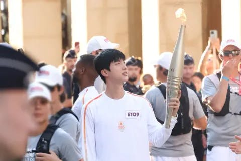 Jin of BTS participates in the Paris 2024 Olympic Torch Relay on July 14, 2024.