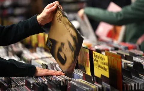 A customer looks through a rack of vinyl records at the HMV store on Oxford street on December 28, 2023.